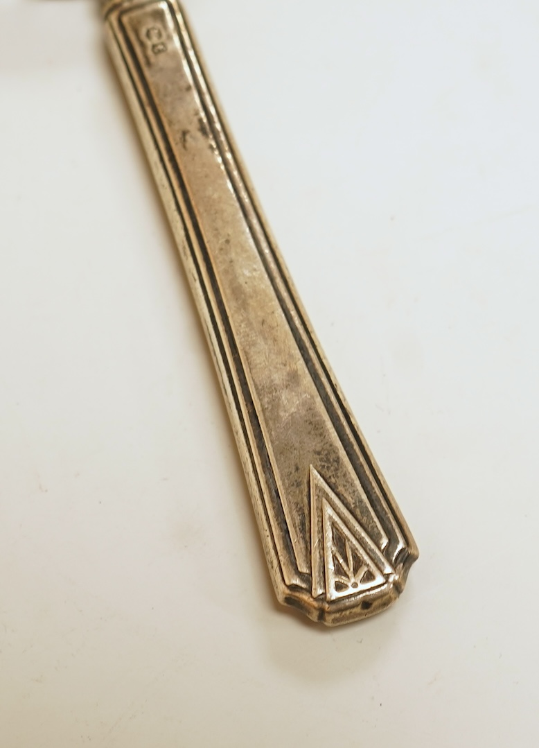 A small silver mounted capstan inkwell, a set of four George V engine turned silver napkin rings and a silver handled magnifying glass.